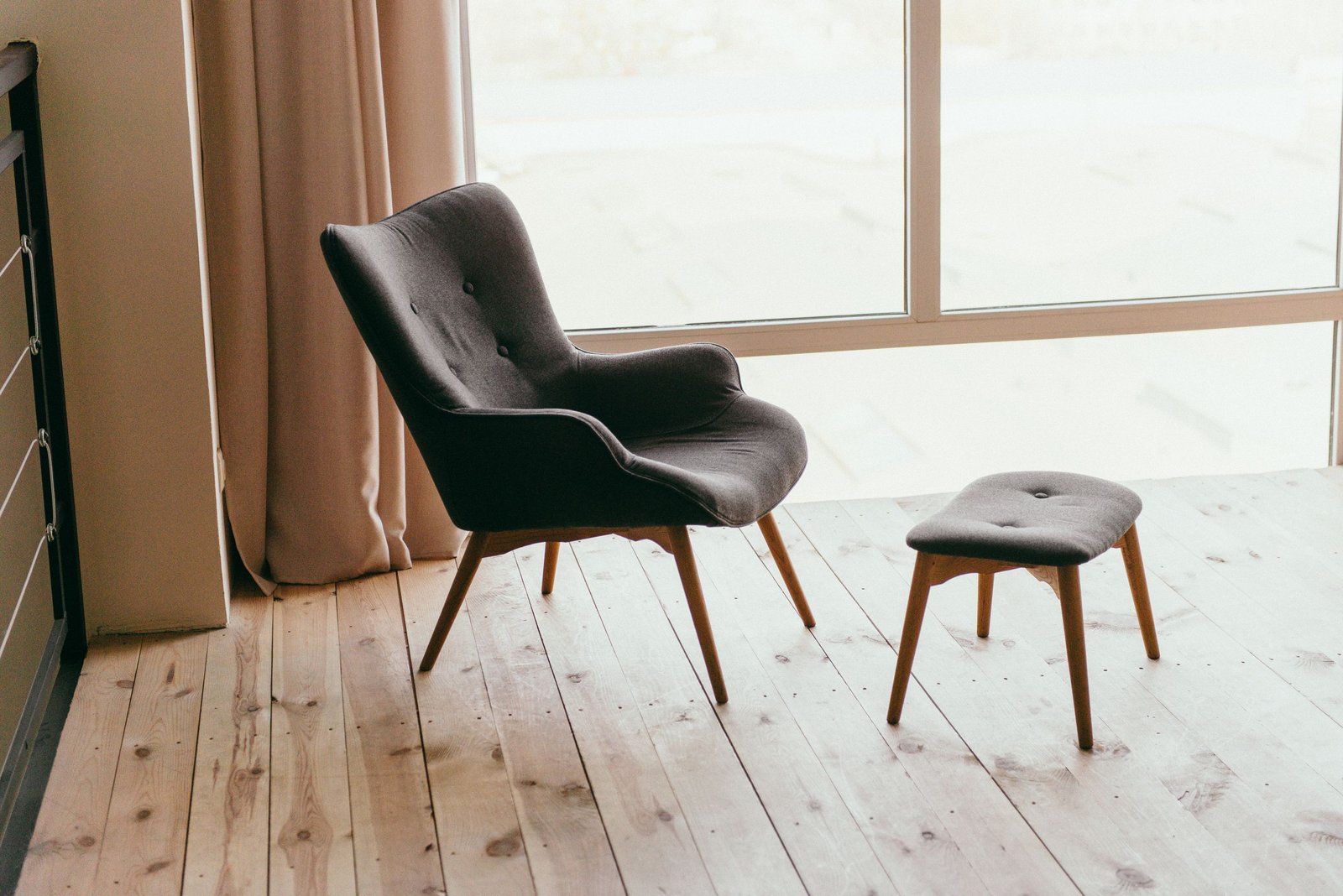 A sculptural lounge chair in a sunlit, calm interior